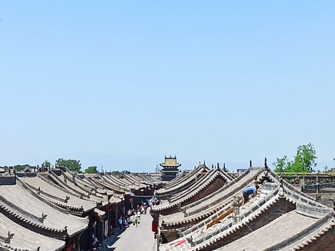 the gray roof of the old building under the blue sky at Pingyao