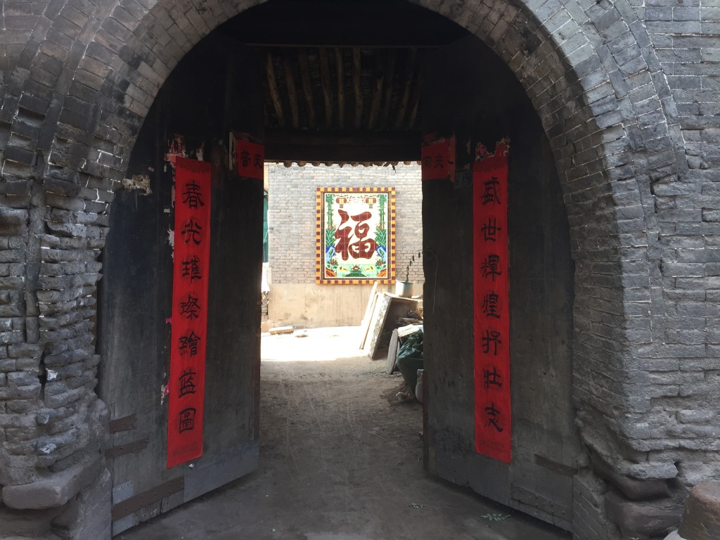 the arch-gate with red couplets and red Fu character of private Shanxi tour